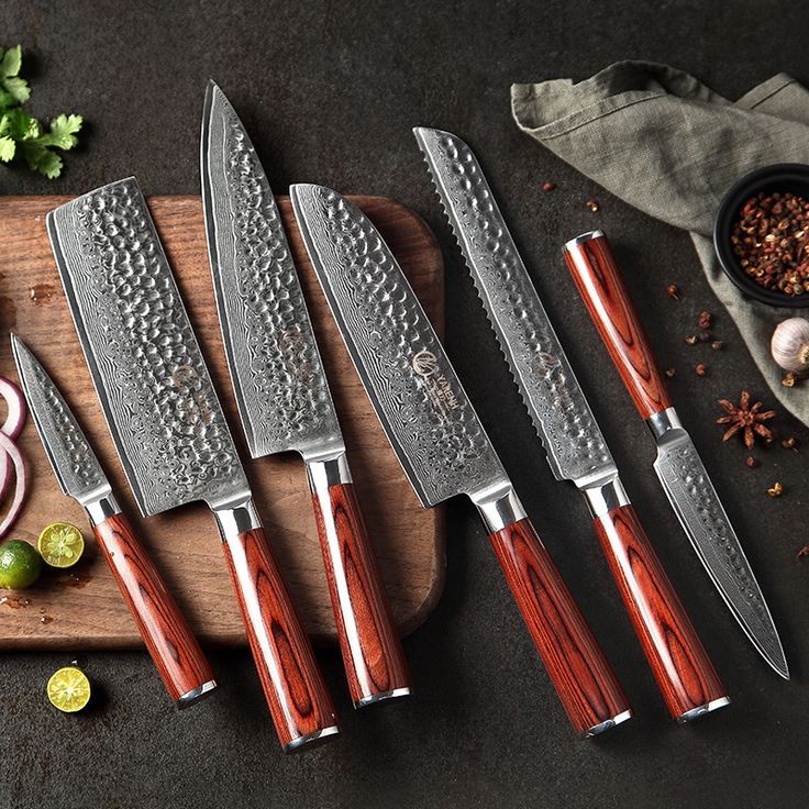 four knives are on a cutting board next to some onions and other vegetables, along with seasonings