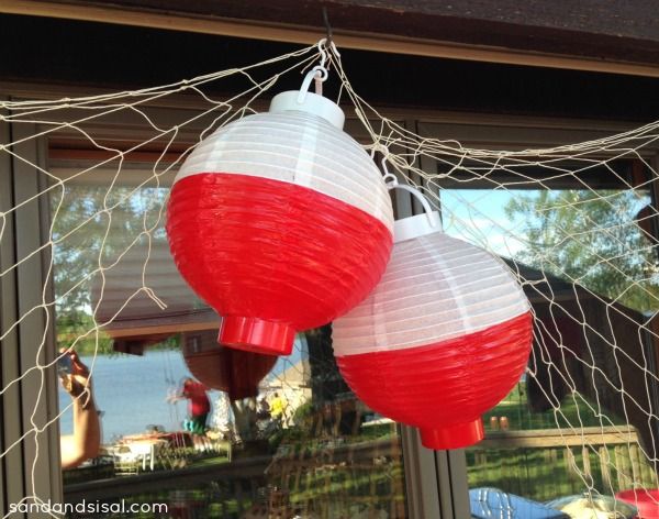 two red and white lanterns hanging from a net