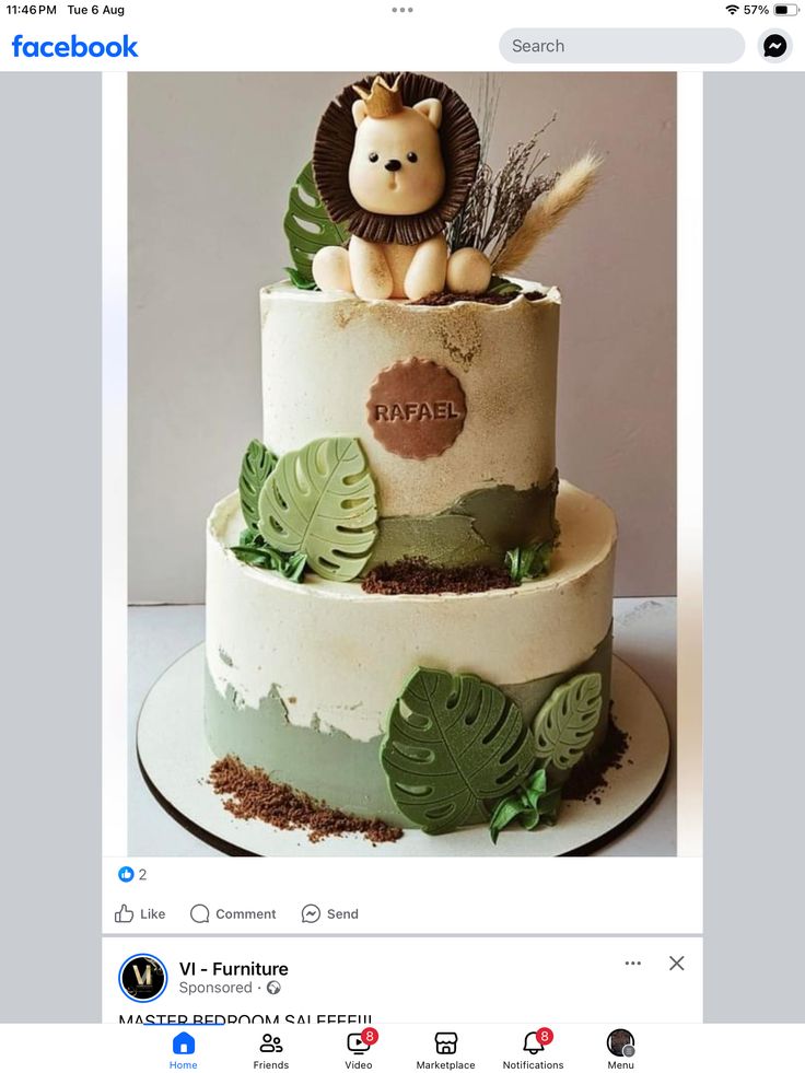 a three tiered cake decorated with leaves and a lion figurine on top