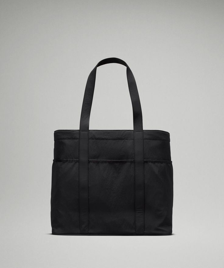 a black tote bag sitting on top of a table