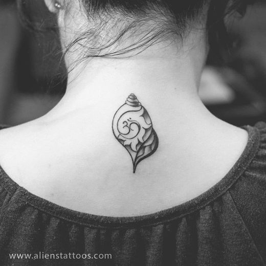 a black and white photo of a woman's neck with a tattoo on it