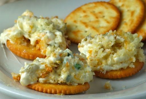 some crackers and cheese on a white plate