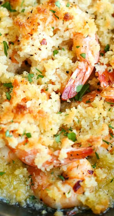 cooked shrimp and rice in a skillet with parsley sprinkled on top