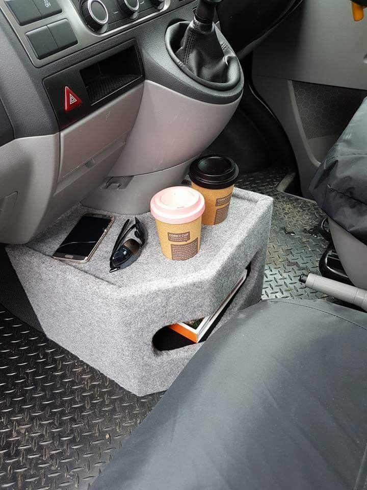 there is a cup holder in the back seat of a car with two cups on it