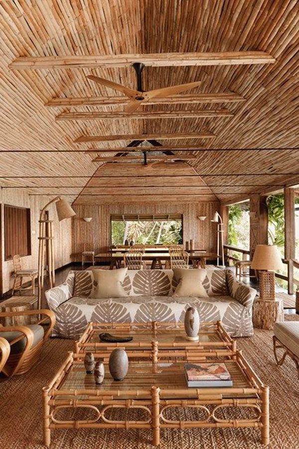 a living room filled with furniture and lots of wood beams on the ceiling above it