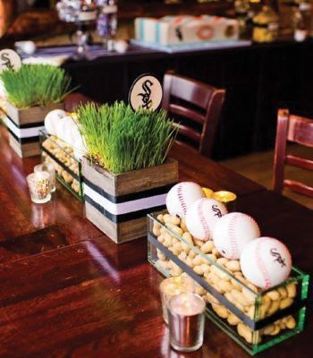 two vases with grass growing out of them on top of a table in a restaurant