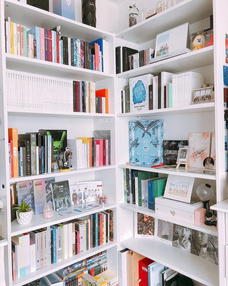 a white book shelf filled with lots of books