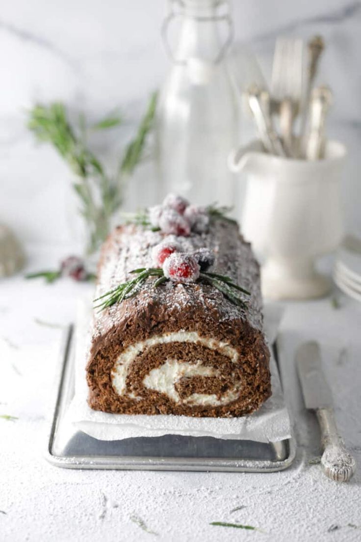 a cake roll with frosting and sprigs on top