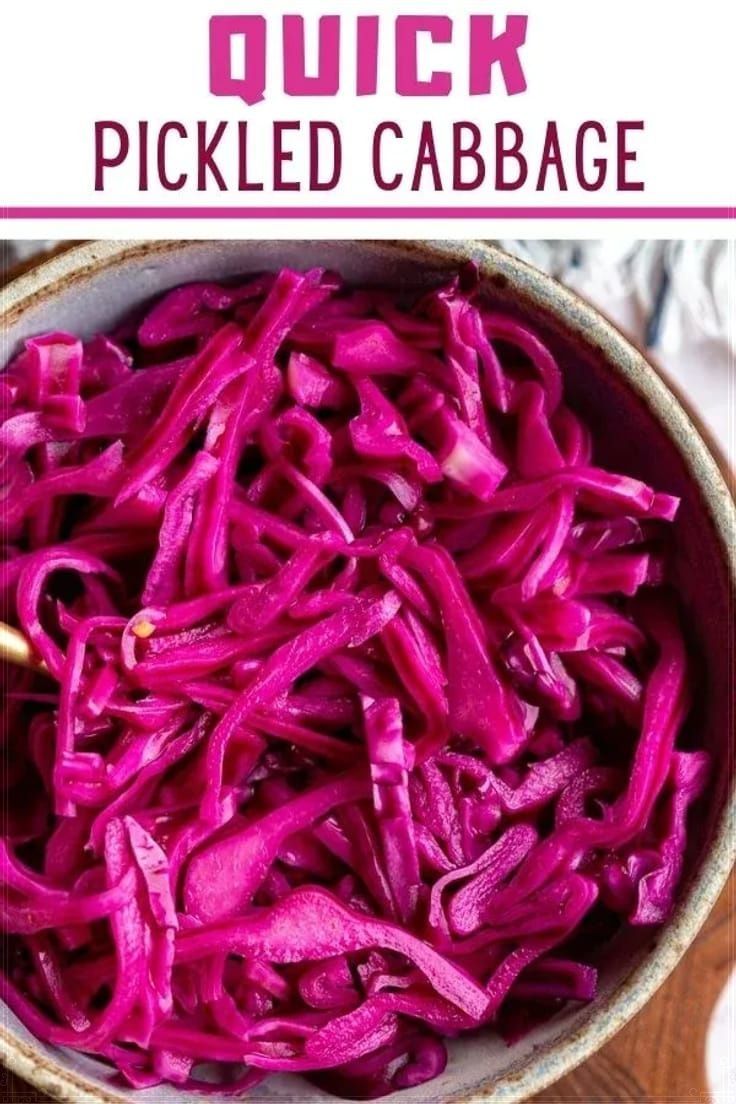 a bowl filled with red cabbage on top of a wooden table