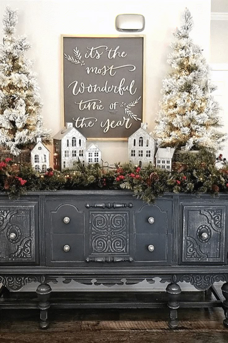 an old dresser is decorated with christmas trees and garlands for the holiday decorating