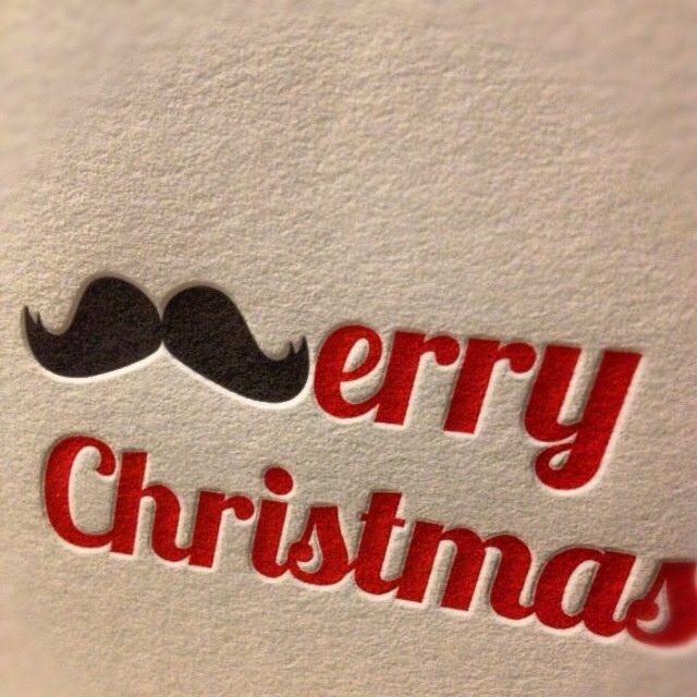 merry christmas sticker with a moustache on the bottom and red lettering below