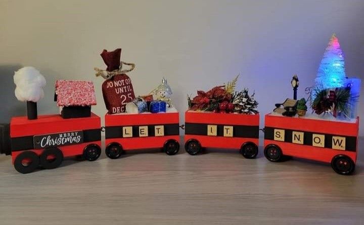 a red and black toy train with christmas decorations