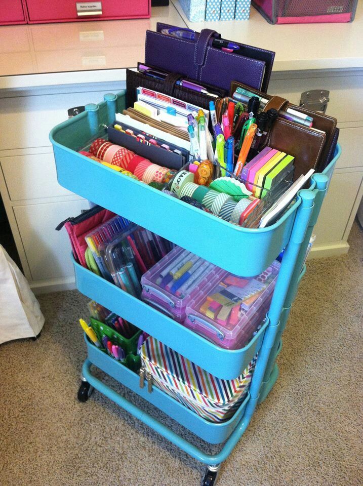 a blue cart filled with lots of office supplies