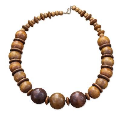 Carrying a promise of beauty wherever it goes this necklace is designed and crafted by Ghanaian artisan Tina Quaye. She carefully selects round beads and discs of brown sese wood that alternate creating a pleasing pattern. Luxury Statement Jewelry With Wooden Beads, Adjustable Round Brown Beaded Necklace, Adjustable Brown Round Beaded Necklace, Adjustable Brown Beaded Round Necklace, Adjustable Brown Beaded Necklace, Bohemian Jewelry With Wooden Beads, Bohemian Single Strand Round Jewelry, Adjustable Brown Beaded Necklace With Round Pendant, Artisan Adjustable Necklace With Round Beads