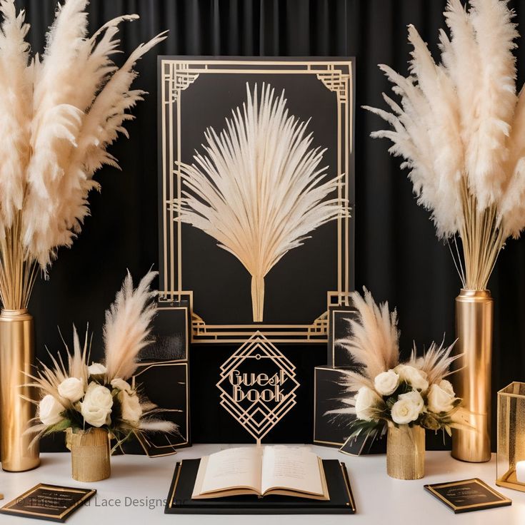 an open book on a table with some flowers and feathers in vases next to it