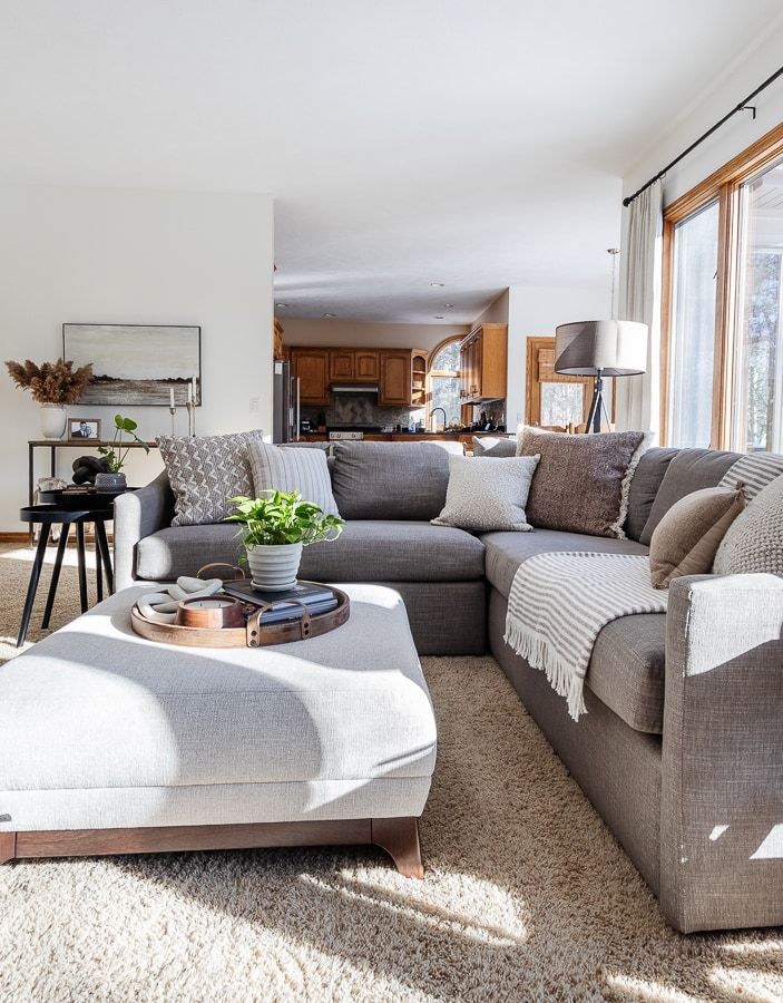 a living room filled with furniture and a large window