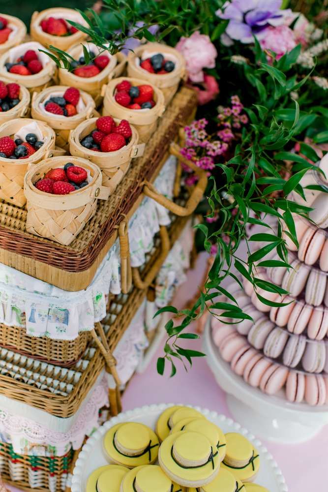 desserts and pastries displayed on wicker trays with flowers in the background