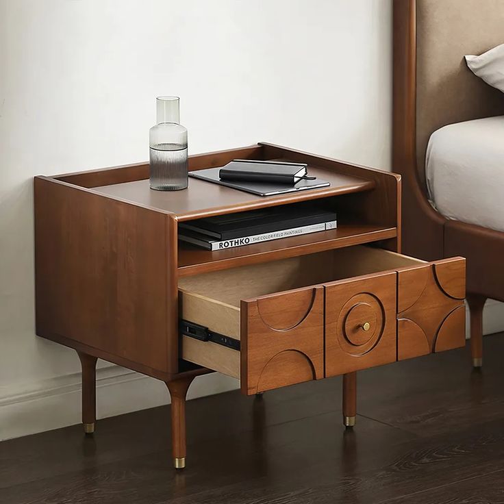 a bed with a wooden headboard and nightstand next to it