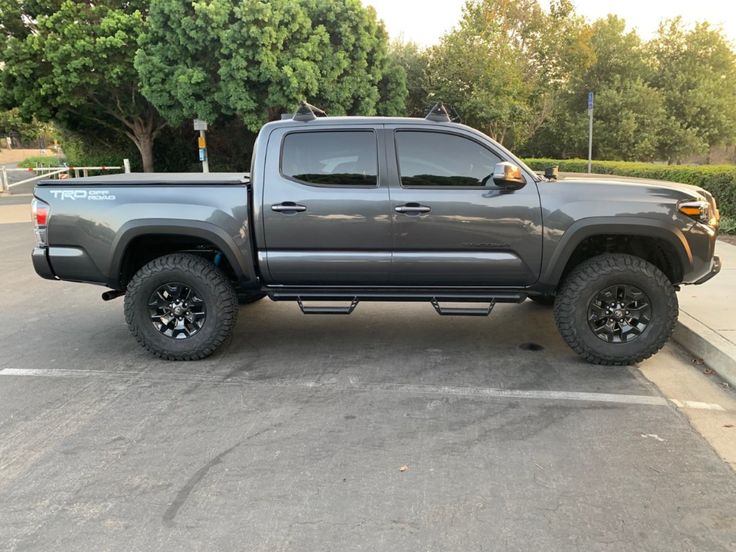 a gray truck parked in a parking lot