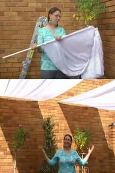 a woman is holding up a white sheet in front of a brick wall and an image of a ladder