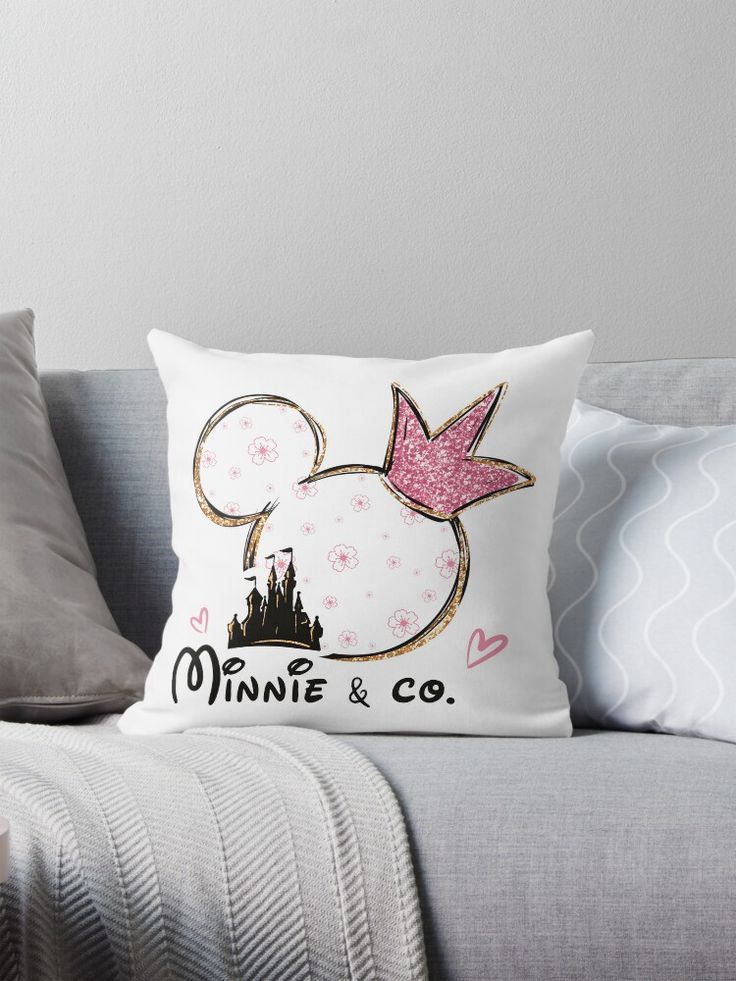 a minnie mouse pillow sitting on top of a couch