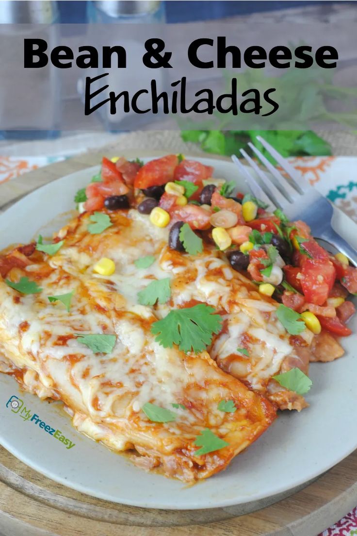 an enchilada on a plate with a fork next to it and the words bean & cheese enchiladas