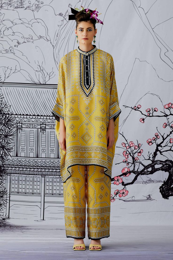 Yellow printed short with asymmetrical hem, featuring all-over printed motif. Paired with co-ordinating  satin pant, in straight legged silhouette.
Component: 2
Printed
Neckline: Band
Sleeve Length: Three Quarter
Fabric: Kurta: Silk; Pant: Satin
Color: Yellow
Contrast black placket
Cuff sleeves
Front button placket
Front belt pant
Back elasticated pant - Aza Fashions Rajdeep Ranawat Collection, Rajdeep Ranawat, Clothing Pattern Design, Indian Fashion Trends, Tunics Online, Iranian Women Fashion, Fashion Design Collection, Pants Fit, Fashionista Clothes