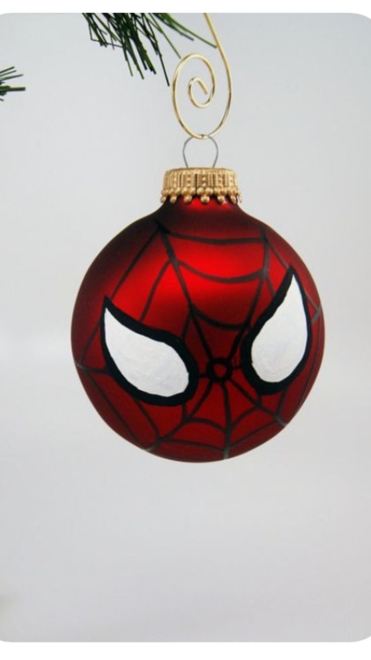 a spiderman ornament hanging from a christmas tree