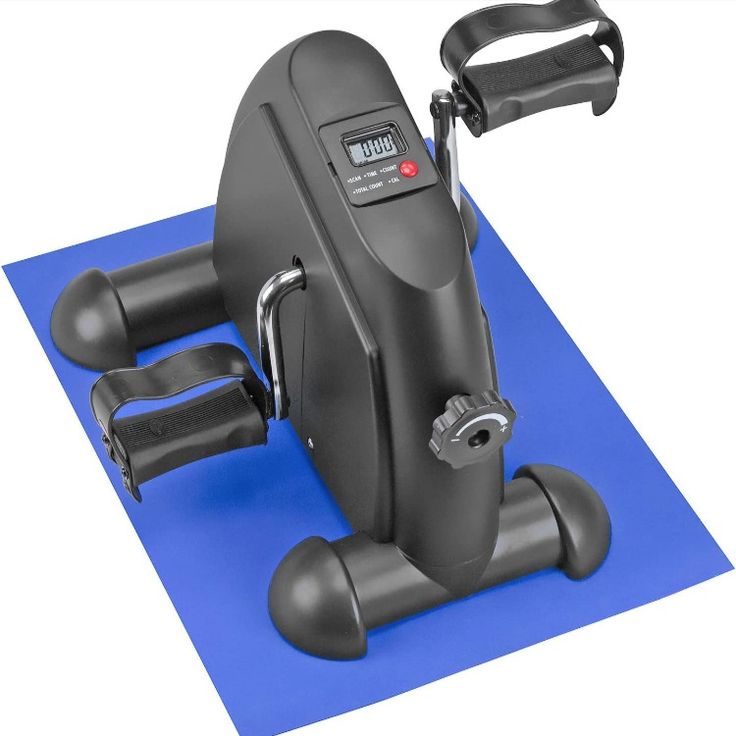 an exercise bike on top of a blue mat