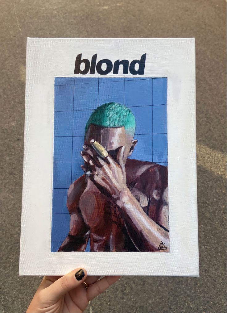 a person holding up a piece of paper with the word blond on it in front of them