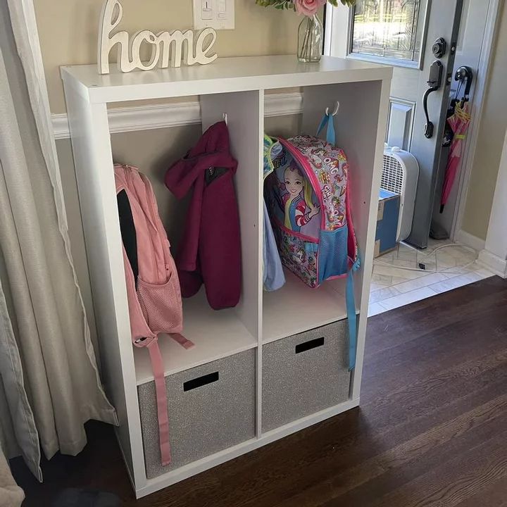 a white shelf filled with lots of items next to a door