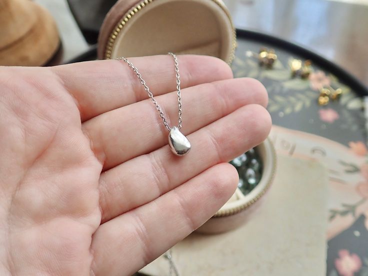 Introducing our Dainty Gold Vermeil Water Drop Necklace, a stunning piece that combines elegance with a touch of nature-inspired charm. Handcrafted with love and attention to detail, this necklace is a perfect accessory to adorn your neckline and add a delicate shimmer to any outfit.Crafted from high quality materials, this necklace features a dainty teardrop pendant, carefully shaped to resemble a beautiful water droplet. The pendant is .925 Sterling Silver plated creating a radiant and long-la Delicate White Gold Teardrop Pendant Necklace, Minimalist Water Drop Jewelry As Gift, Minimalist Water Drop Jewelry For Gifts, Minimalist Water Drop Jewelry Gift, Elegant Silver Hypoallergenic Necklaces, Sterling Silver Drop Necklace Nickel Free, Nickel-free Drop Sterling Silver Necklace, Elegant Hypoallergenic Silver Necklaces, Delicate Teardrop Sterling Silver Charm Necklace