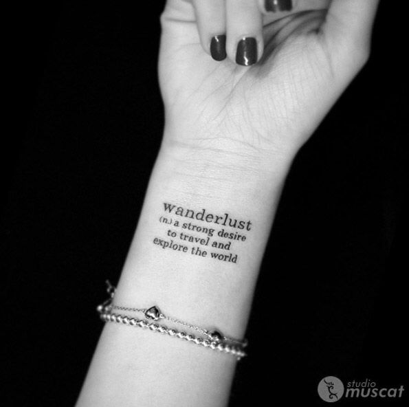 a woman's wrist with a tattoo saying wanderlust is strong and capable to travel the world