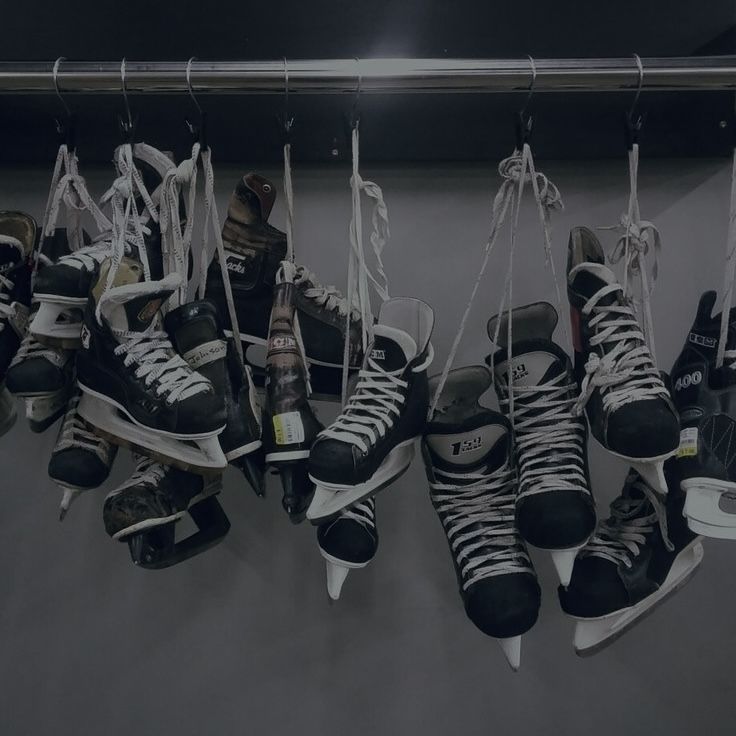 several pairs of ice skates hanging from strings