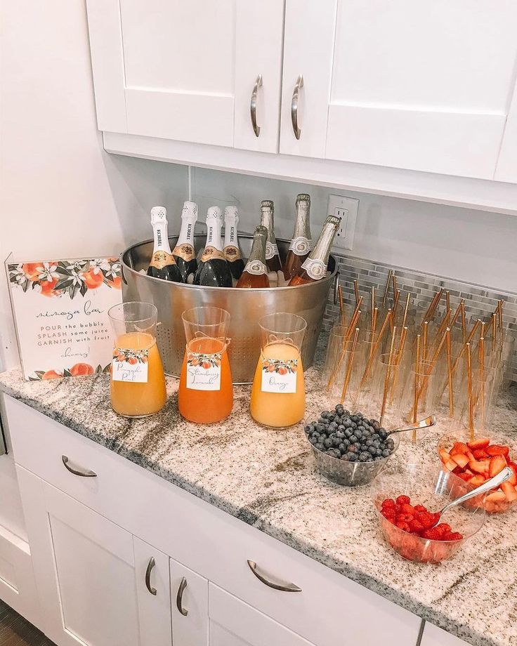 a kitchen counter topped with lots of food and drinks