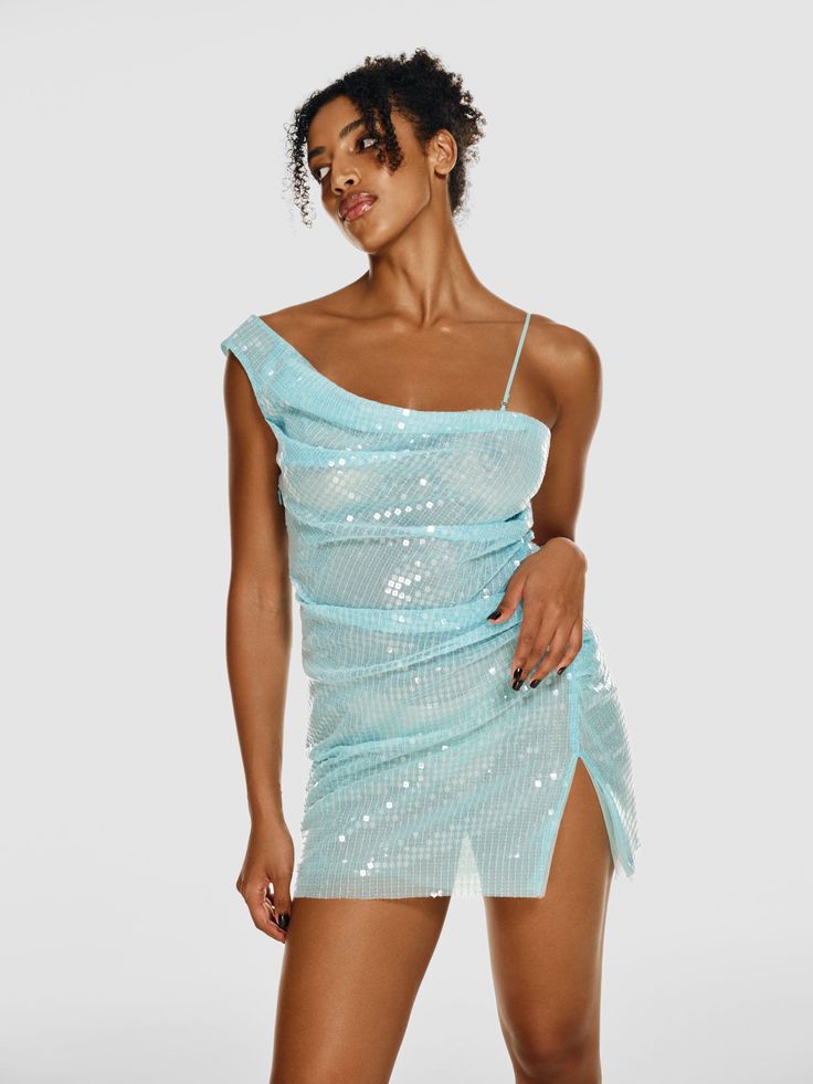 Cut in a one-shoulder silhouette, the BLU MOON mini dress is designed for those nights when you want all eyes on you. It’s made of sky blue sheer net textile covered in glimmering sequins with chic ruching along the sides. Having layers of the fabric to it, the BLU MOON dress is still transparent enough to radiate the Blue Clubbing Outfit, Glamorous Ruched One Shoulder Summer Dress, Glamorous One Shoulder Ruched Summer Dress, Glamorous Ruched One-shoulder Summer Dress, Glamorous One Shoulder Ruched Dress For Night Out, Summer One Shoulder Sequin Dress For Night Out, Summer One Shoulder Dress With Sequins For Night Out, Summer One-shoulder Dress With Sequins For Night Out, One Shoulder Sequin Dress For Summer Night Out