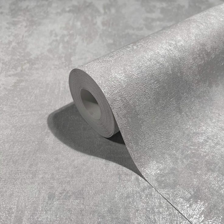 a roll of silver colored paper on top of a table