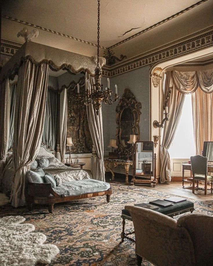 an ornately decorated bedroom with chandelier, bed and chair in the corner