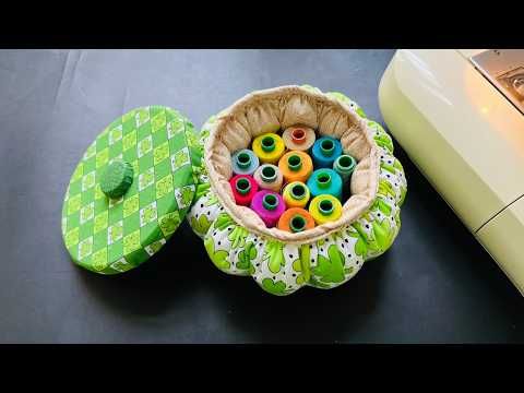 a basket filled with lots of colorful spools next to an electric sewing machine