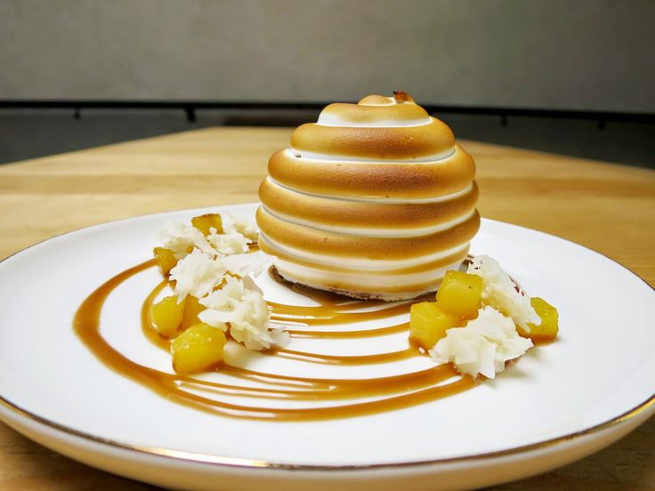 a white plate topped with a desert covered in caramel sauce