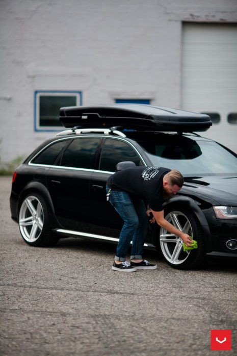 a man working on his car with the hood up