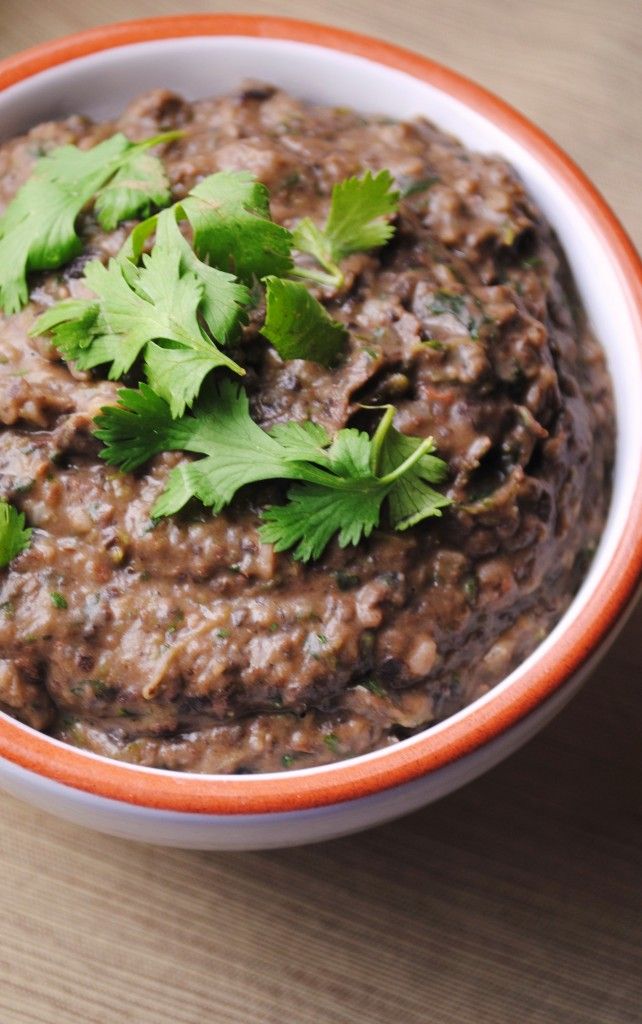 a bowl of black bean dip with cilantro garnish