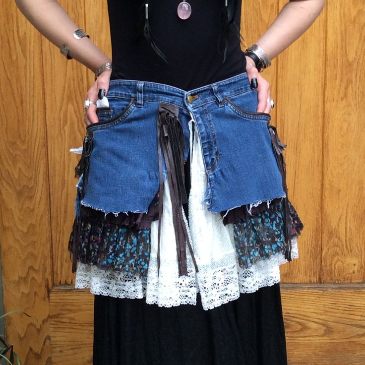 "Handmade Repurposed Wrap Skirt Perfect for summer festivals A combination of mixed textiles including denim, floral print fabric, lace, and brown fringe. No visible signs of wear and tear. Measurements (taken laying flat on front side): Waiste: 31\" Length from waiste: 17 1/2\" Send us a message with any questions! JMM" Bohemian Cotton Skirt With Frayed Hem, Bohemian Bottoms With Frayed Hem For Festivals, Bohemian Festival Bottoms With Frayed Hem, Cotton Skirt With Lace Trim For Festival, Bohemian Fitted Skirt With Frayed Hem, Hippie Upcycled Bottoms For Festival, Upcycled Bohemian Bottoms For Spring, Hippie Festival Bottoms Upcycled, Hippie Fringe Bottoms For Festival