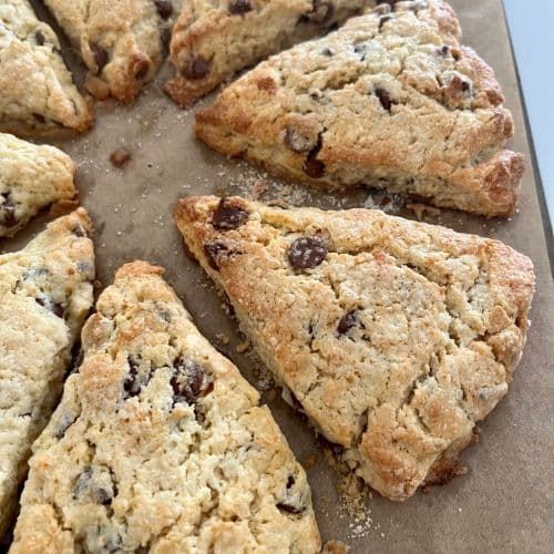 a bunch of cookies that are on top of a table with some chocolate chip toppings