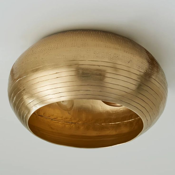 a close up of a light fixture in a room with a white wall behind it