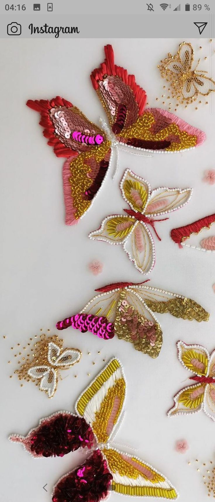 the appliques are made from sequins and fabric, with butterflies on them