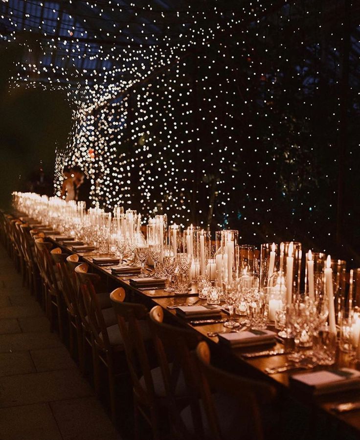 a long table with many glasses and place settings