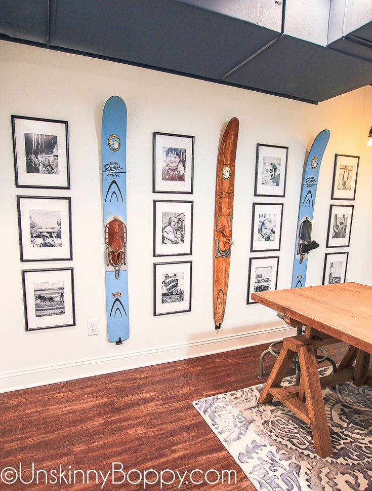 a room with surfboards on the wall and pictures on the wall