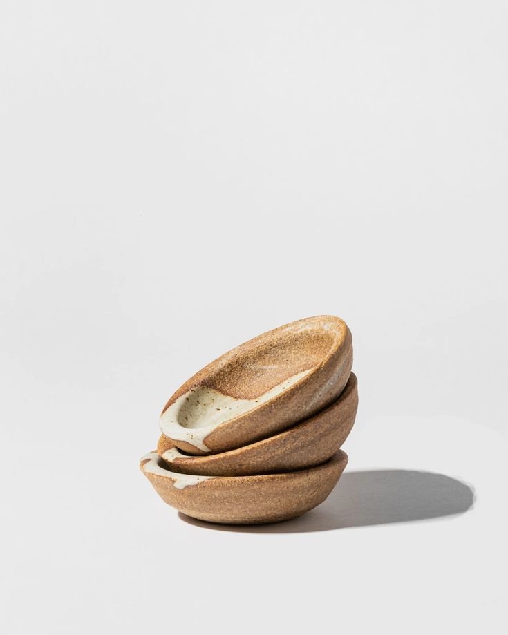 three wooden bowls stacked on top of each other in the shape of an egg shell