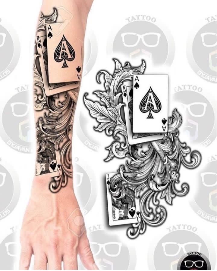 an arm tattoo with playing cards and glasses on the back of it's arm